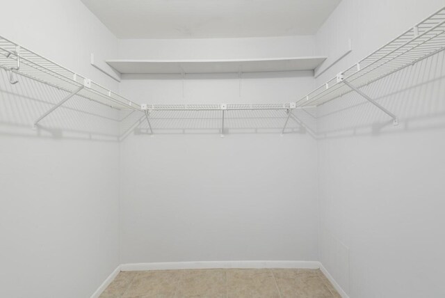 2755 W Atlantic Ave Unit C 212, Delray Beach, FL 33445 - walk in closet featuring light tile patterned floors