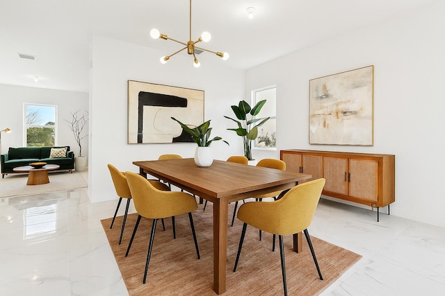 12240 SW 44th Ct, Davie, FL 33330 - dining space featuring light marble finish flooring and a chandelier