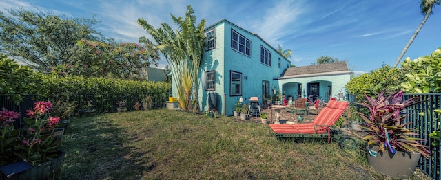 624 10th Ave N, Lake Worth Beach, FL 33460 - rear view of property featuring a fenced backyard and stucco siding