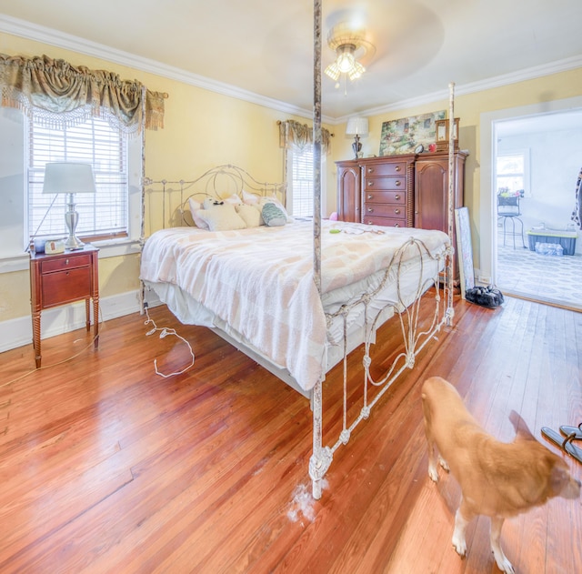 624 10th Ave N, Lake Worth Beach, FL 33460 - bedroom with light wood-type flooring, multiple windows, and crown molding