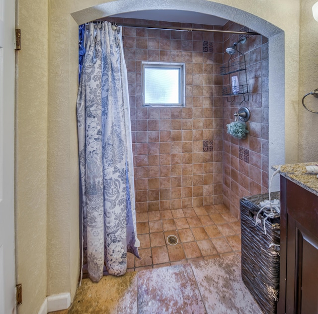 624 10th Ave N, Lake Worth Beach, FL 33460 - full bathroom featuring a textured wall, tiled shower, and vanity