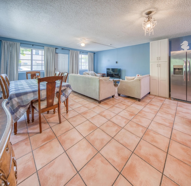 624 10th Ave N, Lake Worth Beach, FL 33460 - dining area featuring a textured ceiling, light tile patterned floors, and a chandelier
