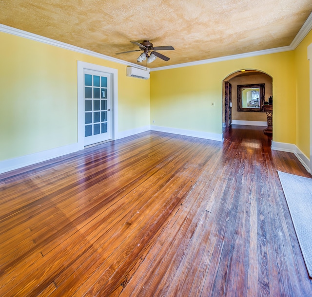 624 10th Ave N, Lake Worth Beach, FL 33460 - unfurnished room featuring a wall mounted AC, arched walkways, wood-type flooring, a ceiling fan, and crown molding