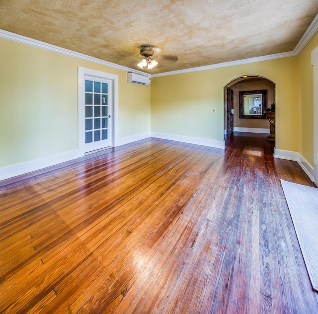 624 10th Ave N, Lake Worth Beach, FL 33460 - empty room with a wall mounted AC, arched walkways, hardwood / wood-style flooring, a ceiling fan, and crown molding