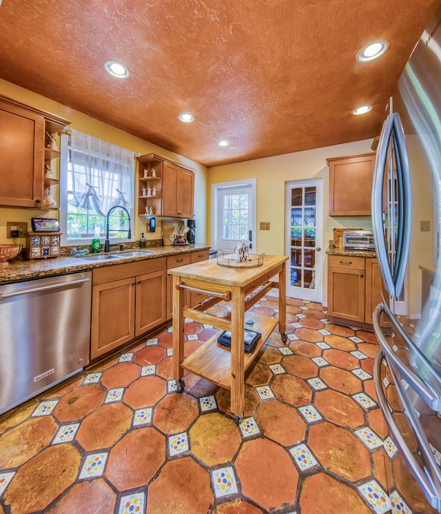 624 10th Ave N, Lake Worth Beach, FL 33460 - kitchen featuring appliances with stainless steel finishes, open shelves, recessed lighting, brown cabinets, and a textured ceiling
