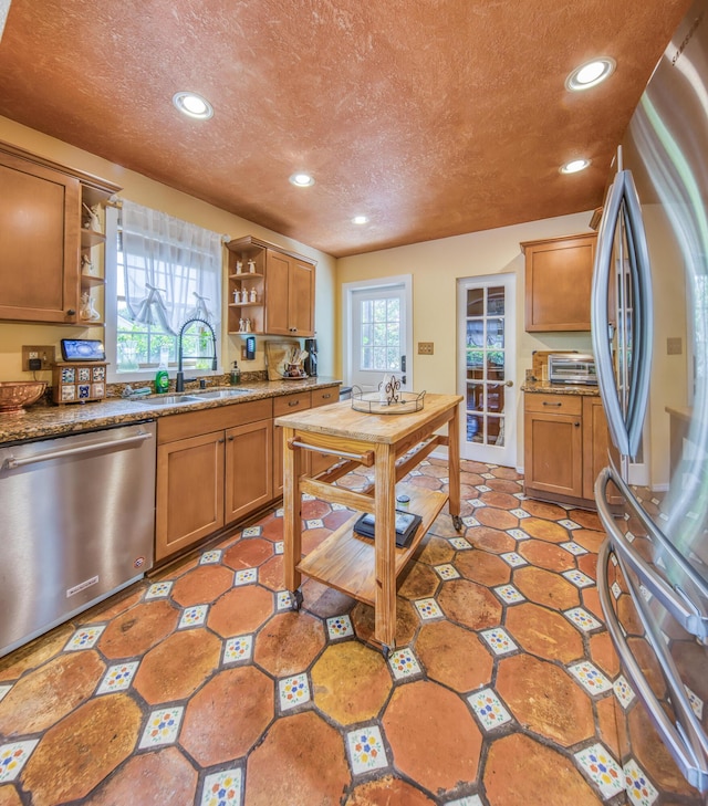 624 10th Ave N, Lake Worth Beach, FL 33460 - kitchen featuring stainless steel appliances, open shelves, a textured ceiling, recessed lighting, and brown cabinetry