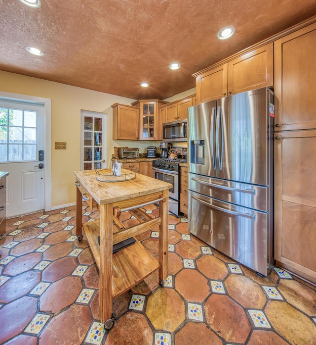 624 10th Ave N, Lake Worth Beach, FL 33460 - kitchen with appliances with stainless steel finishes, recessed lighting, glass insert cabinets, and brown cabinets