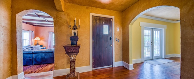 624 10th Ave N, Lake Worth Beach, FL 33460 - foyer entrance featuring arched walkways, wood-type flooring, and beamed ceiling