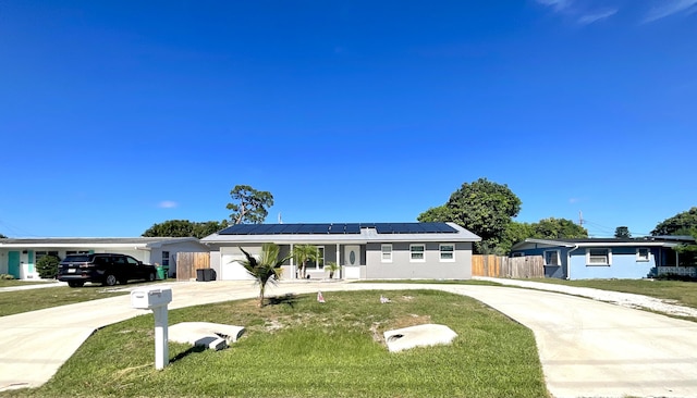 409 NE Oleander Ave, Port Saint Lucie, FL 34952 - single story home featuring concrete driveway, roof mounted solar panels, a metal roof, stucco siding, and a standing seam roof