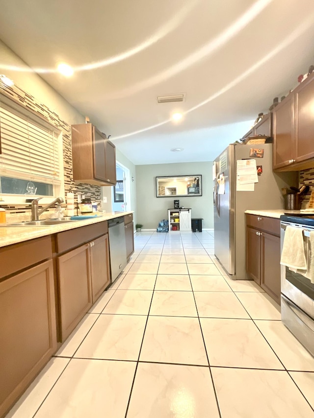 409 NE Oleander Ave, Port Saint Lucie, FL 34952 - kitchen with appliances with stainless steel finishes, light countertops, and light tile patterned floors