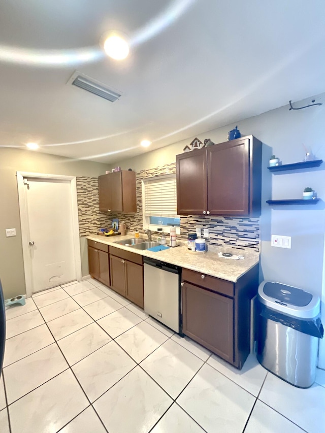 409 NE Oleander Ave, Port Saint Lucie, FL 34952 - kitchen featuring dishwasher, decorative backsplash, light countertops, and light tile patterned floors