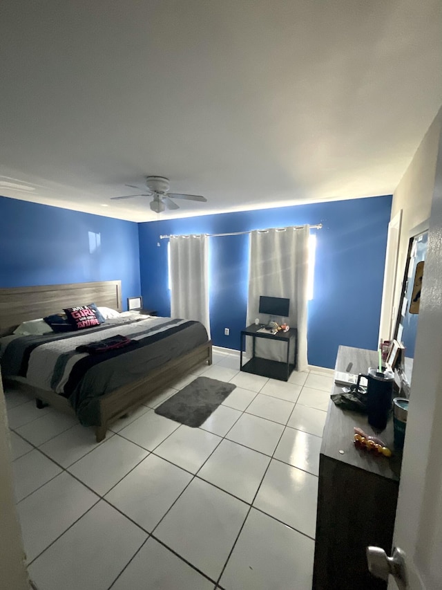 409 NE Oleander Ave, Port Saint Lucie, FL 34952 - bedroom featuring light tile patterned floors and a ceiling fan