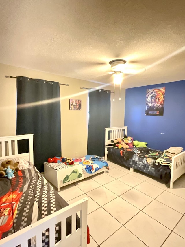 409 NE Oleander Ave, Port Saint Lucie, FL 34952 - tiled bedroom featuring a textured ceiling and ceiling fan