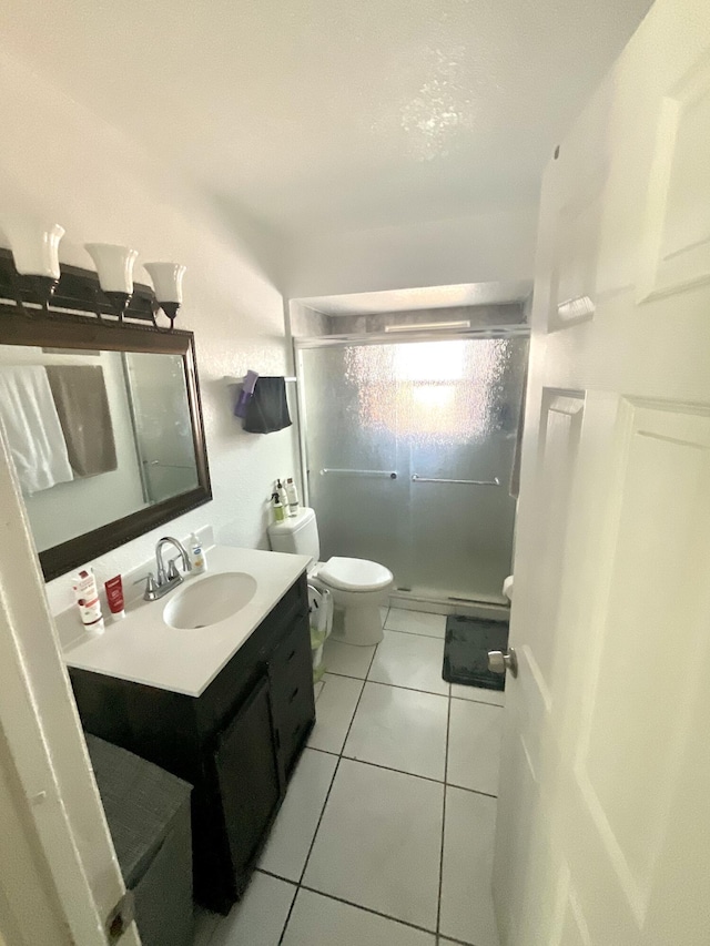 409 NE Oleander Ave, Port Saint Lucie, FL 34952 - full bathroom with vanity, a shower stall, and tile patterned floors