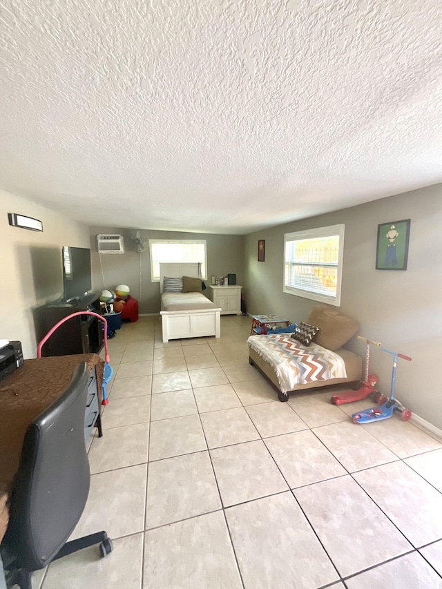 409 NE Oleander Ave, Port Saint Lucie, FL 34952 - bedroom featuring a wall mounted AC, a textured ceiling, and light tile patterned flooring