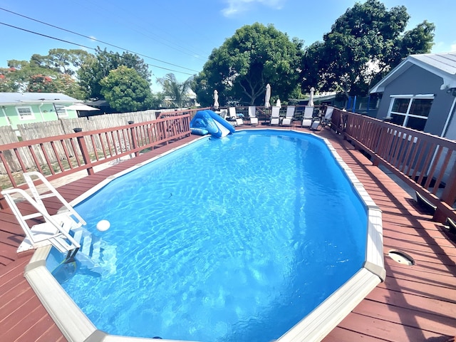 409 NE Oleander Ave, Port Saint Lucie, FL 34952 - view of pool with a fenced backyard and a deck