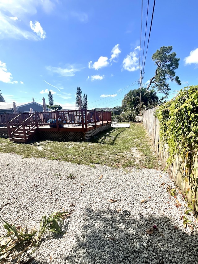 409 NE Oleander Ave, Port Saint Lucie, FL 34952 - rear view of property featuring a wooden deck