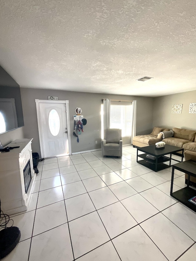 409 NE Oleander Ave, Port Saint Lucie, FL 34952 - living area with a textured ceiling, healthy amount of natural light, and light tile patterned floors