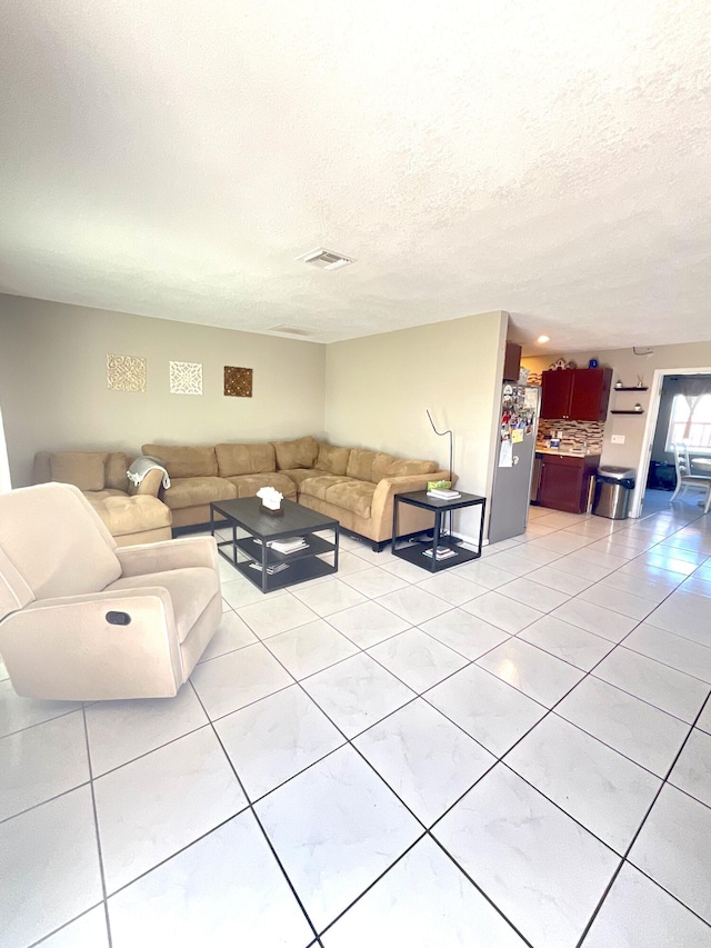 409 NE Oleander Ave, Port Saint Lucie, FL 34952 - living area featuring light tile patterned flooring and a textured ceiling