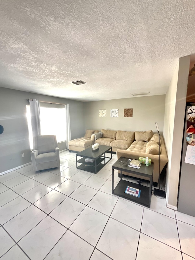 409 NE Oleander Ave, Port Saint Lucie, FL 34952 - tiled living room with a textured ceiling