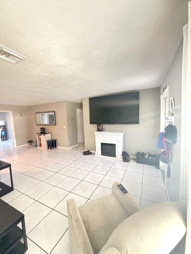 409 NE Oleander Ave, Port Saint Lucie, FL 34952 - living area with tile patterned floors, a textured ceiling, and a fireplace