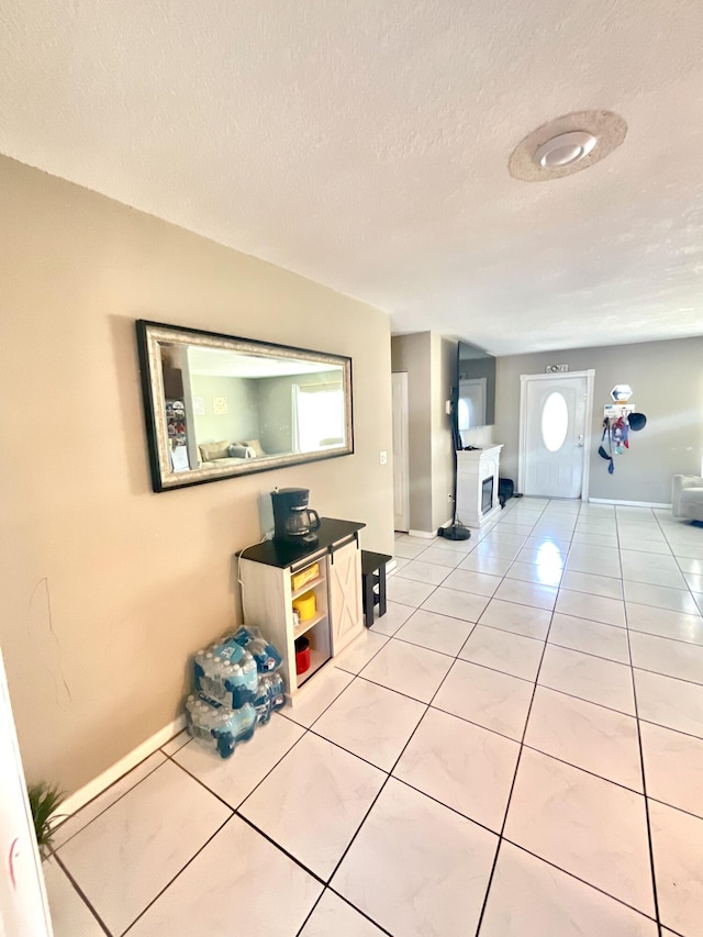 409 NE Oleander Ave, Port Saint Lucie, FL 34952 - hall featuring light tile patterned flooring and a textured ceiling