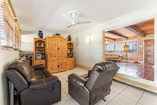 918 Grace Ave, Lake Worth, FL 33461 - living room with ceiling fan, light tile patterned floors, wood walls, and beam ceiling