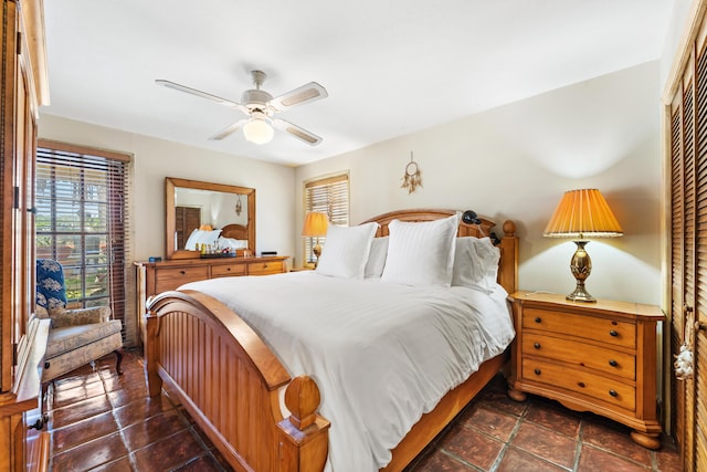918 Grace Ave, Lake Worth, FL 33461 - bedroom with dark tile patterned flooring, a ceiling fan, and a closet