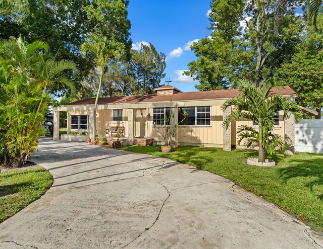 918 Grace Ave, Lake Worth, FL 33461 - view of front facade featuring concrete driveway and a front yard