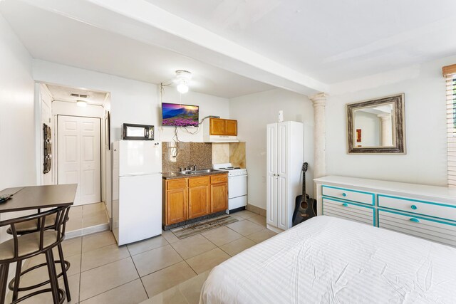 918 Grace Ave, Lake Worth, FL 33461 - bedroom with freestanding refrigerator and light tile patterned floors
