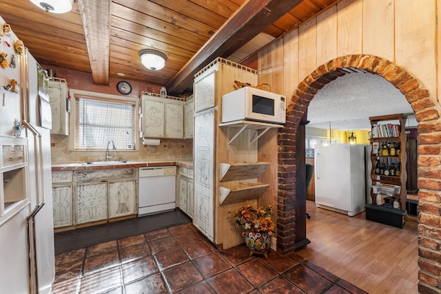 918 Grace Ave, Lake Worth, FL 33461 - kitchen with white appliances, arched walkways, wooden ceiling, decorative backsplash, and tile counters
