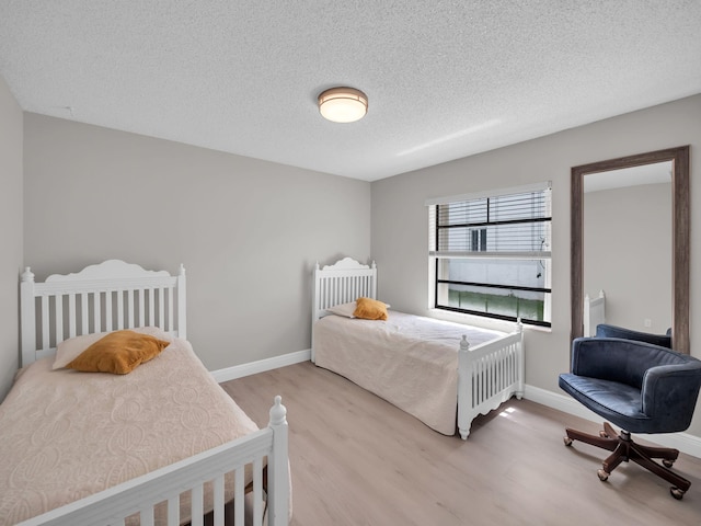 1598 SW 19th St, Boca Raton, FL 33486 - bedroom with light wood-style floors and a textured ceiling