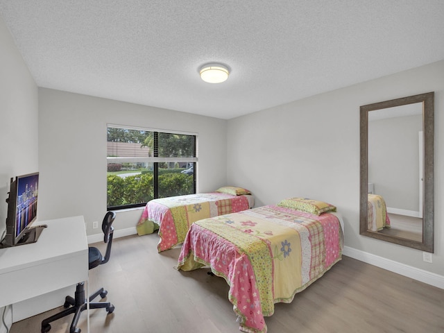 1598 SW 19th St, Boca Raton, FL 33486 - bedroom featuring wood finished floors, a desk, and a textured ceiling