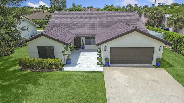 1598 SW 19th St, Boca Raton, FL 33486 - view of front facade with a tiled roof, driveway, a garage, stucco siding, and a front yard