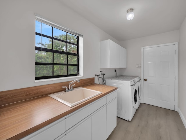 1598 SW 19th St, Boca Raton, FL 33486 - laundry area featuring cabinet space, washer and clothes dryer, and light wood-type flooring
