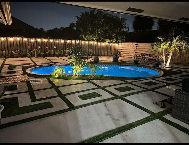 1598 SW 19th St, Boca Raton, FL 33486 - pool at twilight with a fenced backyard and a patio area