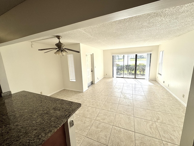 1119 Green Pine Blvd Unit C1, West Palm Beach, FL 33409 - unfurnished living room with light tile patterned flooring, ceiling fan, and a textured ceiling