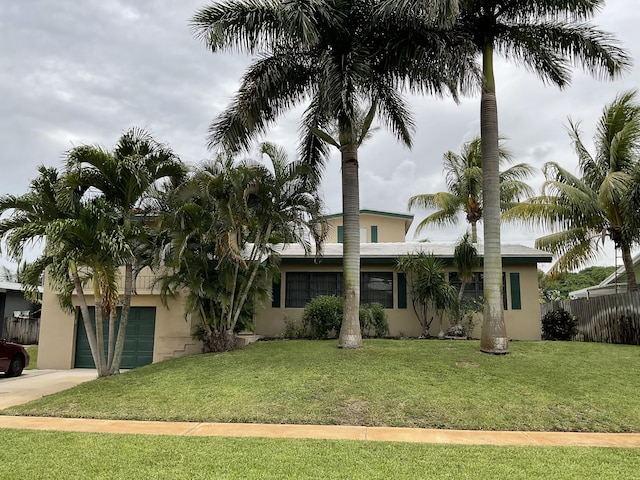 1319 Lake Erie Dr, Lake Worth, FL 33461 - view of front of house featuring stucco siding, driveway, and an attached garage