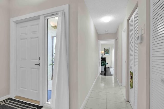 18619 Breezy Palm Way, Boca Raton, FL 33496 - foyer with light tile patterned floors and a textured ceiling