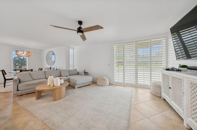 2200 S Ocean Blvd Unit 102, Delray Beach, FL 33483 - living area with light tile patterned floors, a ceiling fan, and a chandelier