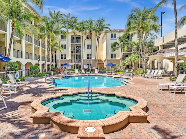 2 Renaissance Way Unit 302, Boynton Beach, FL 33426 - community pool featuring a hot tub and a patio area
