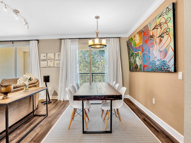 2 Renaissance Way Unit 302, Boynton Beach, FL 33426 - dining space featuring ornamental molding, dark wood-style floors, and a textured wall