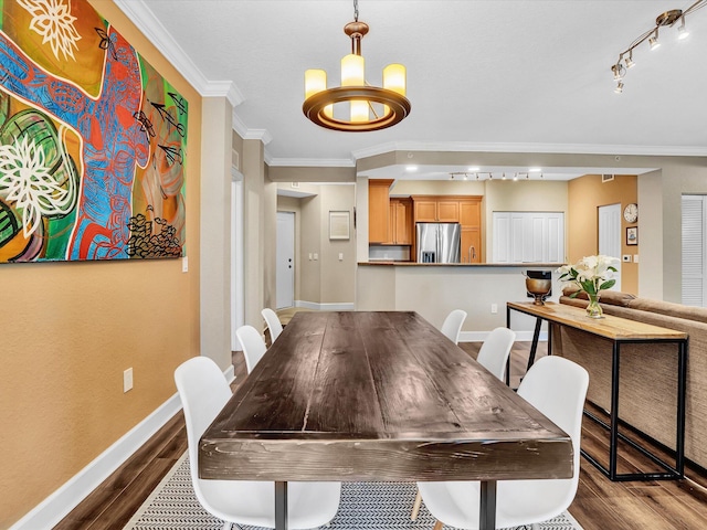 2 Renaissance Way Unit 302, Boynton Beach, FL 33426 - dining area with dark wood finished floors, crown molding, track lighting, and a chandelier