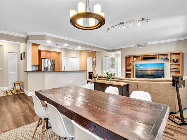 2 Renaissance Way Unit 302, Boynton Beach, FL 33426 - dining space featuring dark wood-type flooring, ornamental molding, and rail lighting