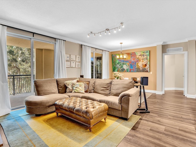 2 Renaissance Way Unit 302, Boynton Beach, FL 33426 - living area featuring crown molding, a chandelier, and light wood-style floors