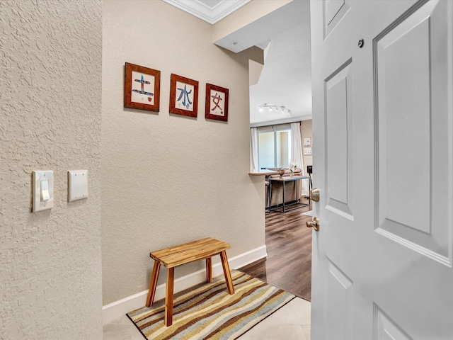 2 Renaissance Way Unit 302, Boynton Beach, FL 33426 - corridor featuring a textured wall, crown molding, and tile patterned floors