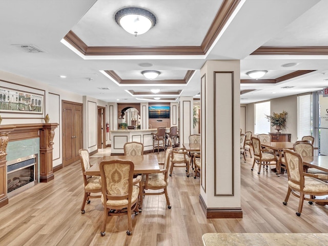 2 Renaissance Way Unit 302, Boynton Beach, FL 33426 - dining room with a tile fireplace, a tray ceiling, ornamental molding, and light wood-style flooring