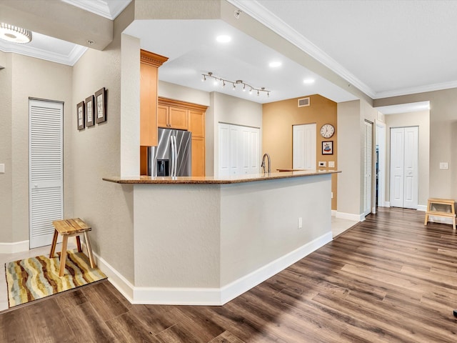 2 Renaissance Way Unit 302, Boynton Beach, FL 33426 - kitchen with stainless steel fridge with ice dispenser, dark wood-style floors, crown molding, and light stone counters