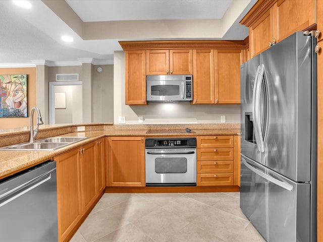 2 Renaissance Way Unit 302, Boynton Beach, FL 33426 - kitchen with appliances with stainless steel finishes, crown molding, light tile patterned flooring, brown cabinetry, and recessed lighting
