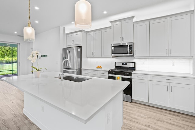 11695 SW Viridian Blvd, Port Saint Lucie, FL 34987 - kitchen featuring stainless steel appliances, backsplash, light countertops, light wood-style flooring, and recessed lighting